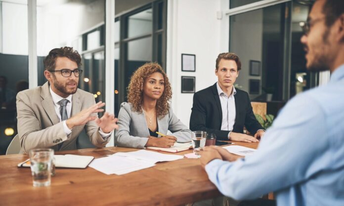 Shot of a group of businesspeople interviewing a candidate in an office